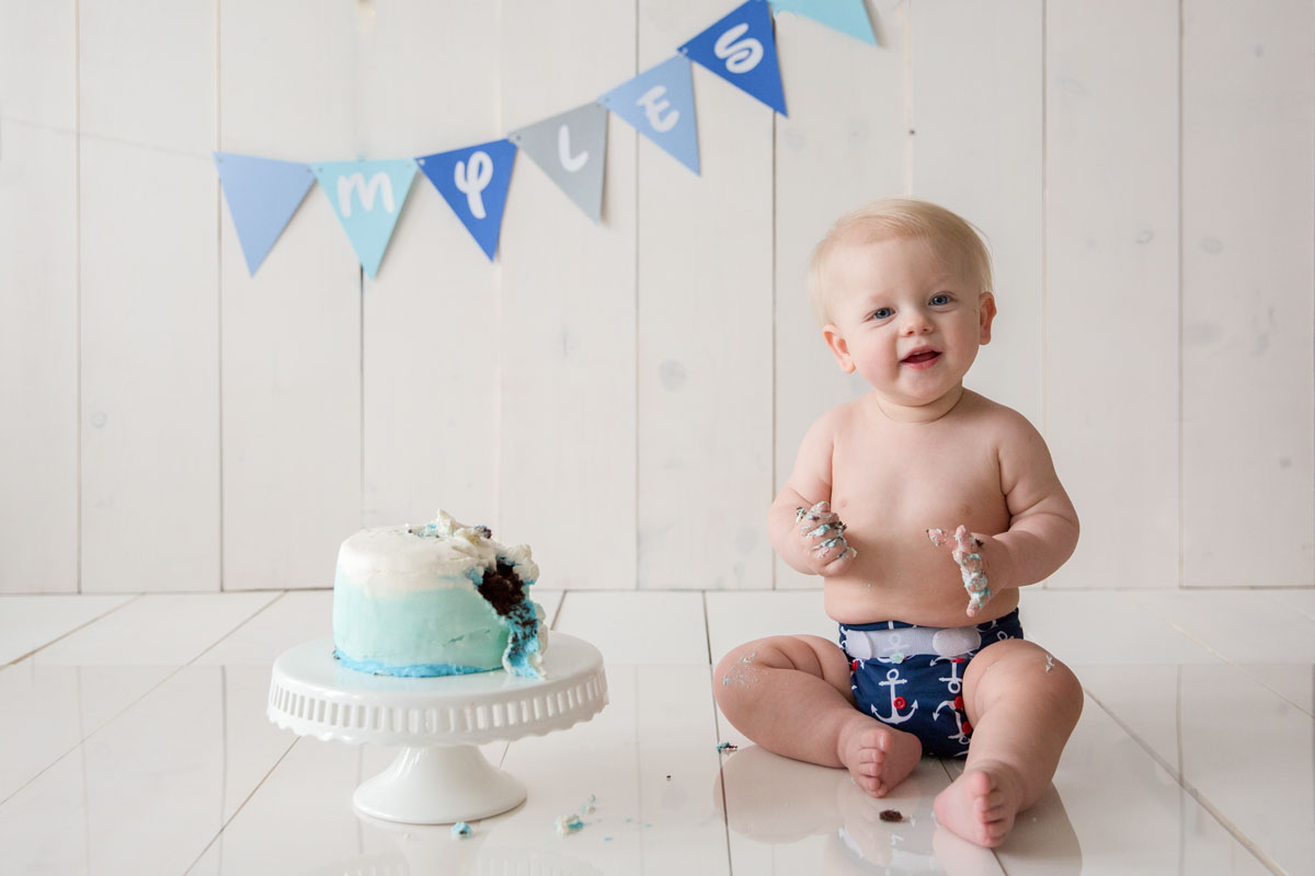Lexington, KY baby photographer picture of baby boy with a blue cake smash cake