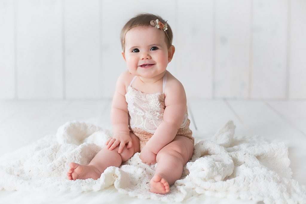 Harrodsburg, KY newborn photographer picture of a 6 month old sitting on a white blanket