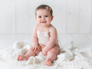 Harrodsburg, KY newborn photographer picture of a 6 month old sitting on a white blanket