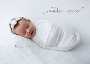 Newborn baby swaddled and smiling in an image captured by Rhonda Cunningham, Newborn Photographer in Lexington, KY
