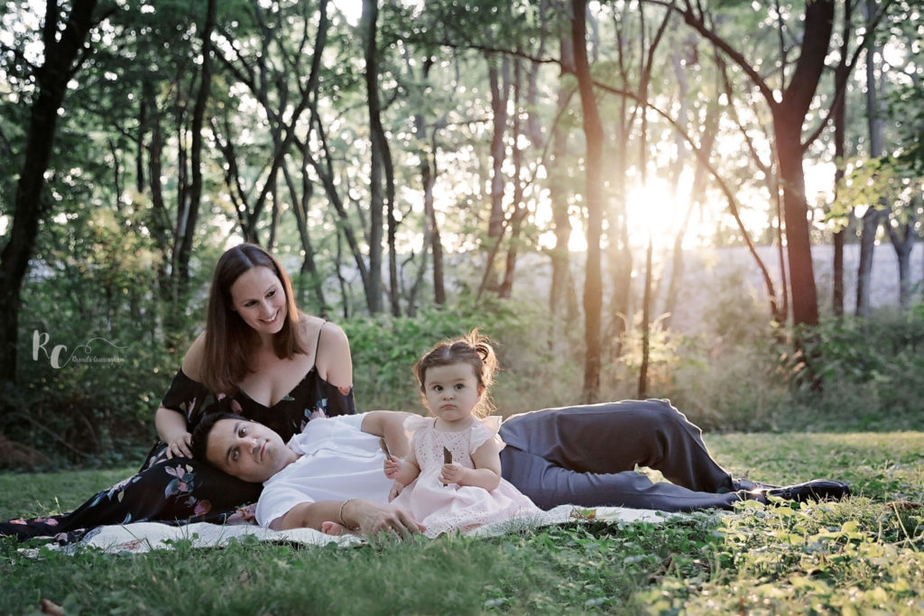 One year Portrait Session of family with sun setting in the background captured by Rhonda Cunningham Photography, a Lexington, Ky Photographer.