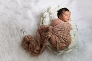 Lexington, KY Newborn pictures with baby wrapped in pink in a basket