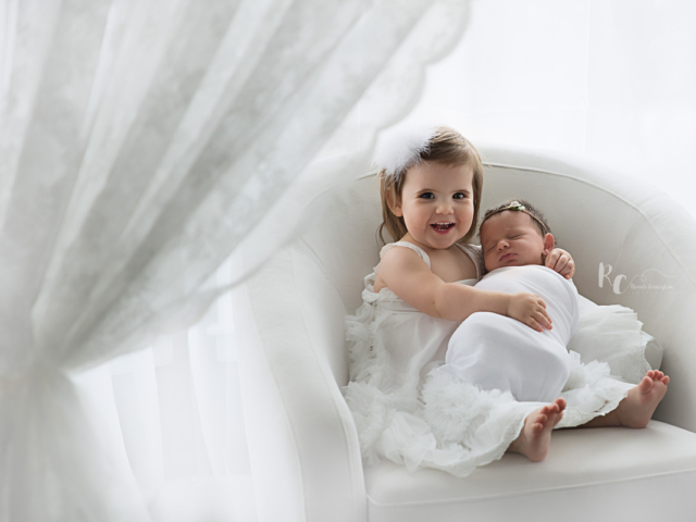2 year old holding her newborn baby sister by lexington ky newborn photographer, Rhonda Cunningham Photography